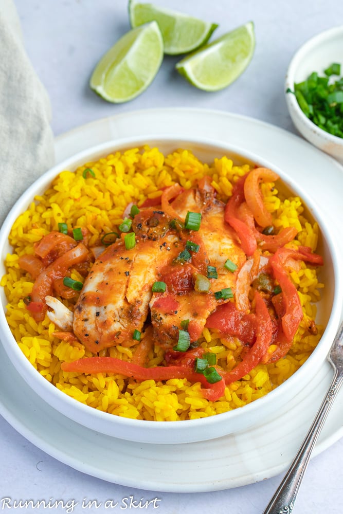 Tilapia Fish Veracruz in a white bowl with spanish rice.