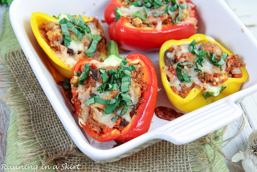Vegetarian Italian Stuffed Peppers in a white baking dish with cheese on top.