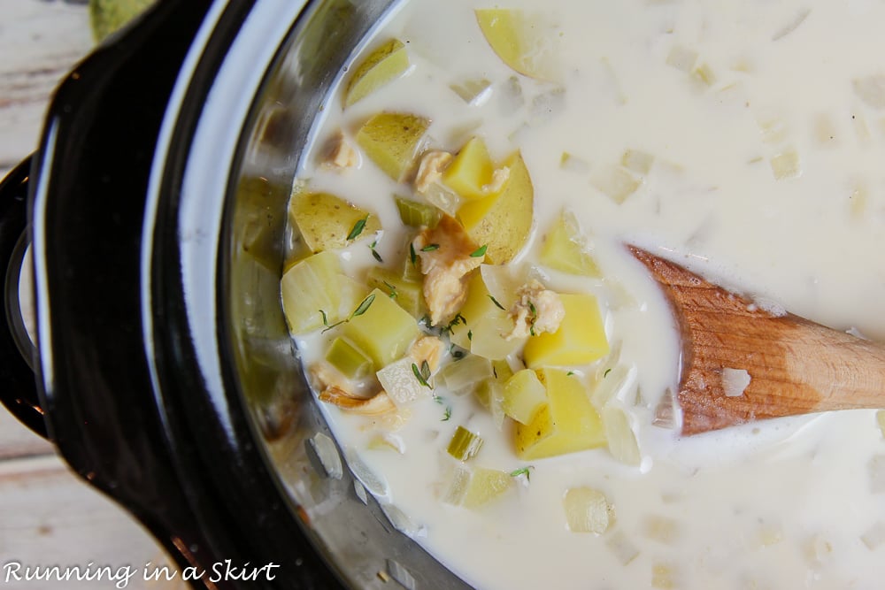 Overhead shot of the clam chowder in a slow cooker.