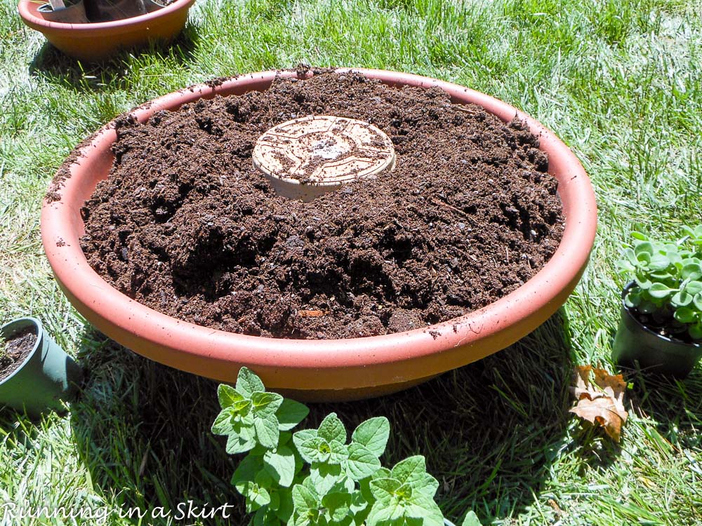 How to Make and Herb Tower process shot showing how to fill the pot with dirt.