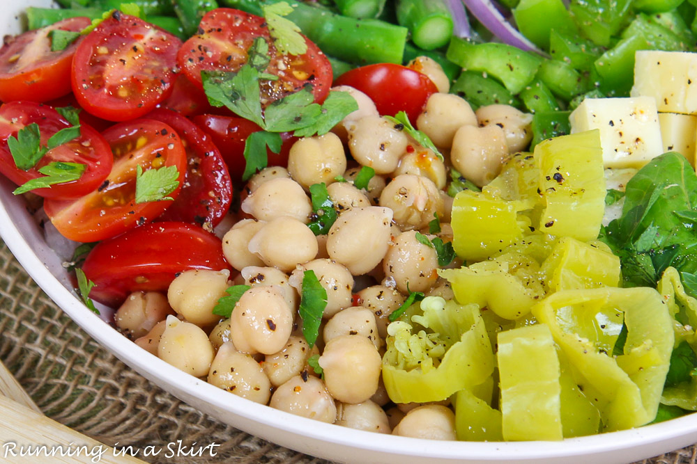 Close up of Italian Chopped Salad recipe with tomatoes, chickpeas and cheese.