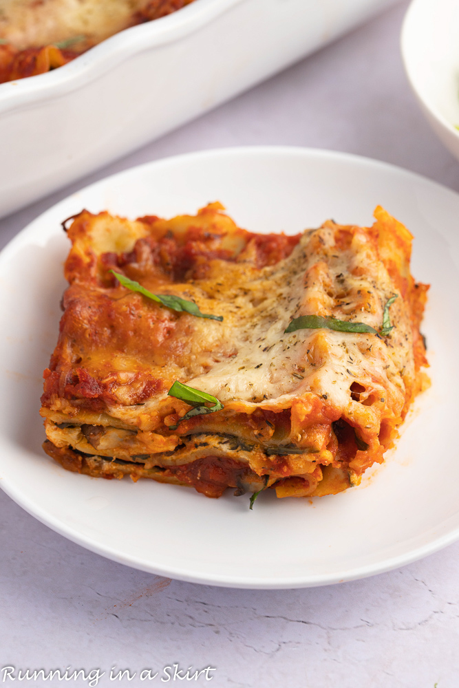 Spinach Mushroom Lasagna slice cut out on a white plate.