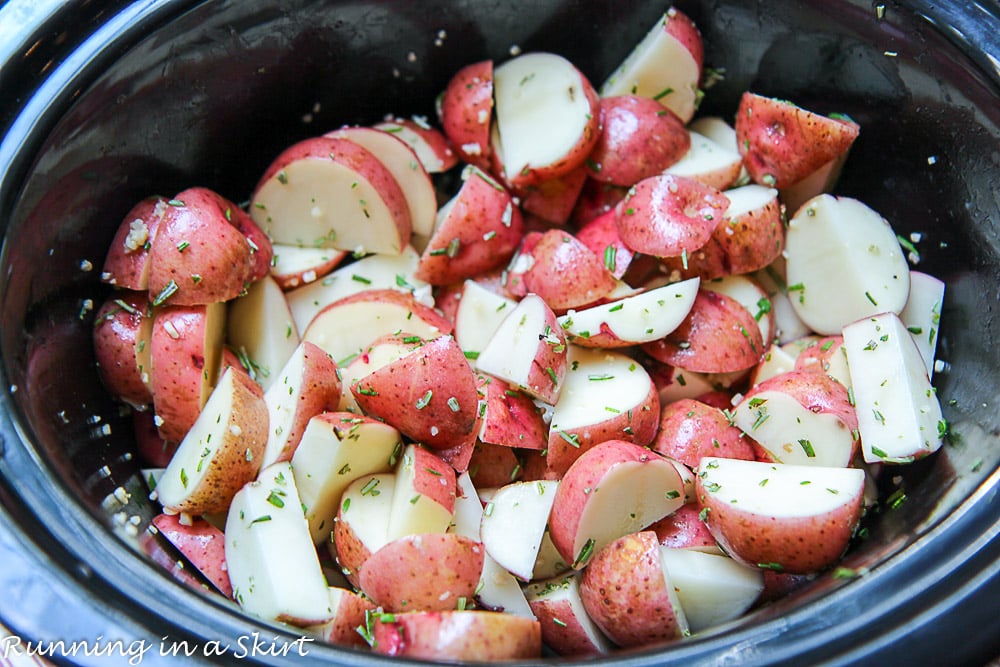 Raw red potatoes cooking in the crock pot.