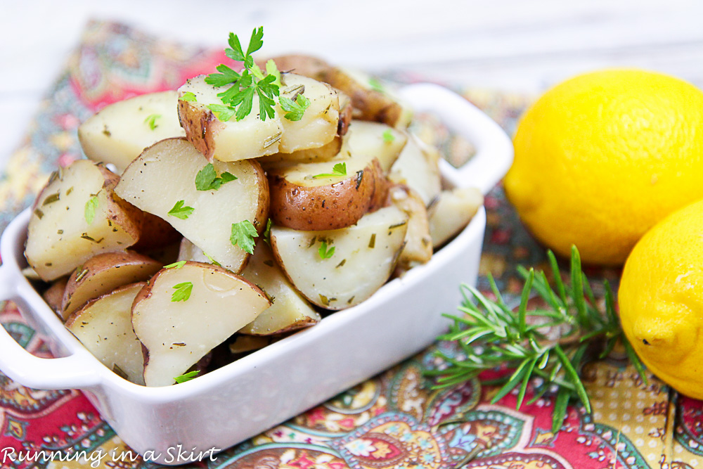 Crock Pot Rosemary Potatoes in a white bowl with lemon.