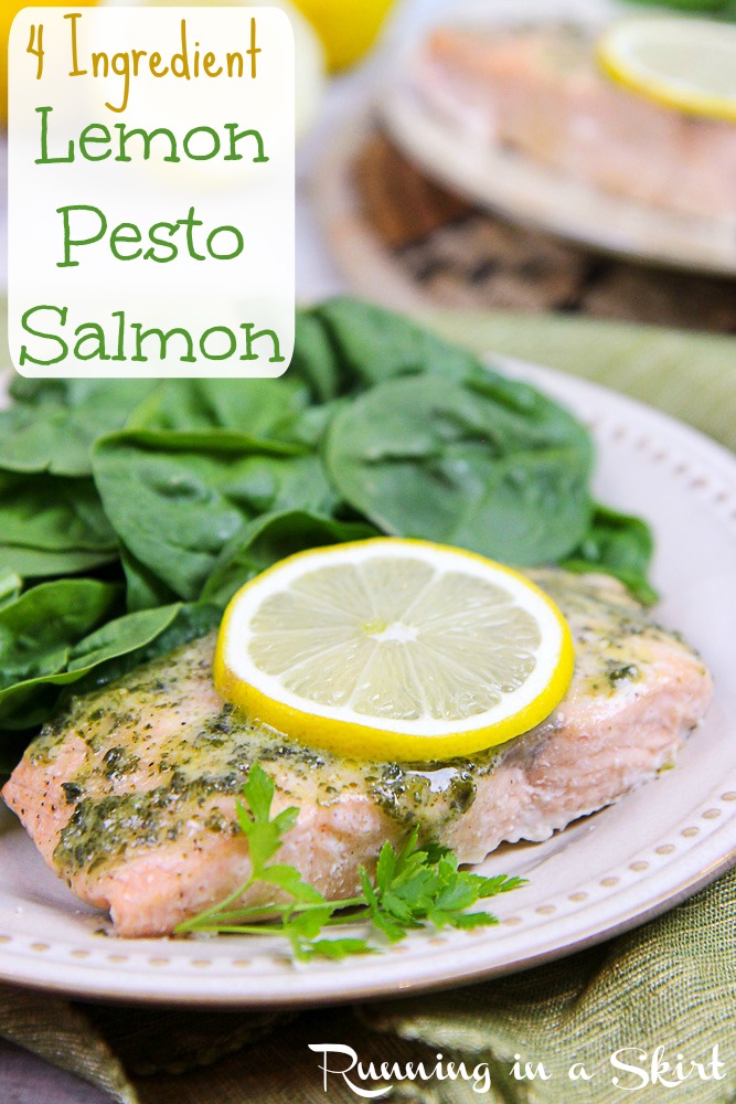 Salmon with a lemon slice and salad on a white plate.