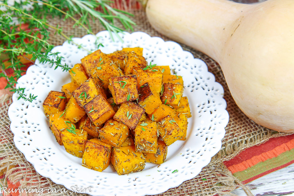 Oven Roasted Butternut Squash recipe on a white plate with a whole butternut squash.