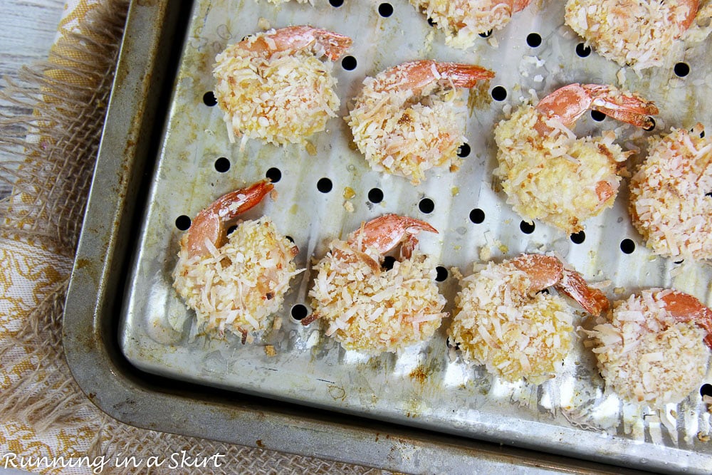 Oven Baked Coconut Shrimp coming out of the oven on a tray.