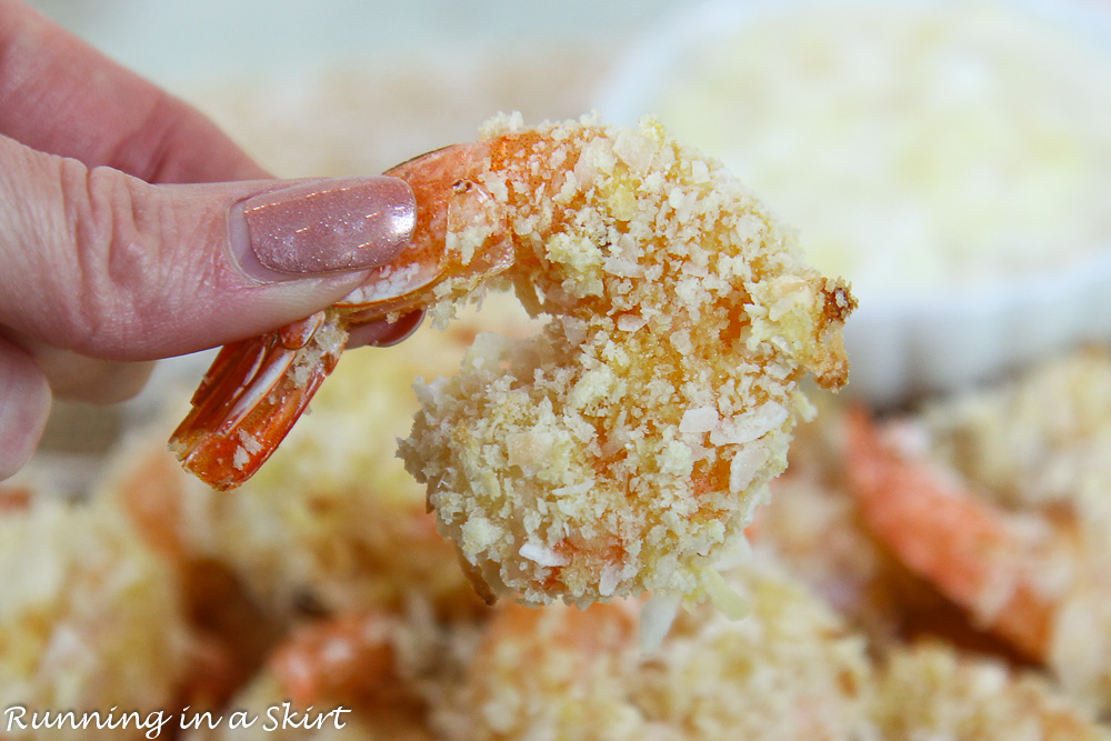 Hand holding the coconut shrimp.