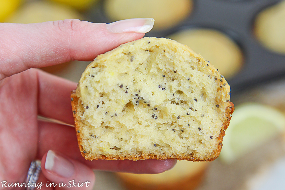 Healthy Lemon Poppy Seed Muffins cut in half with hand holding it.