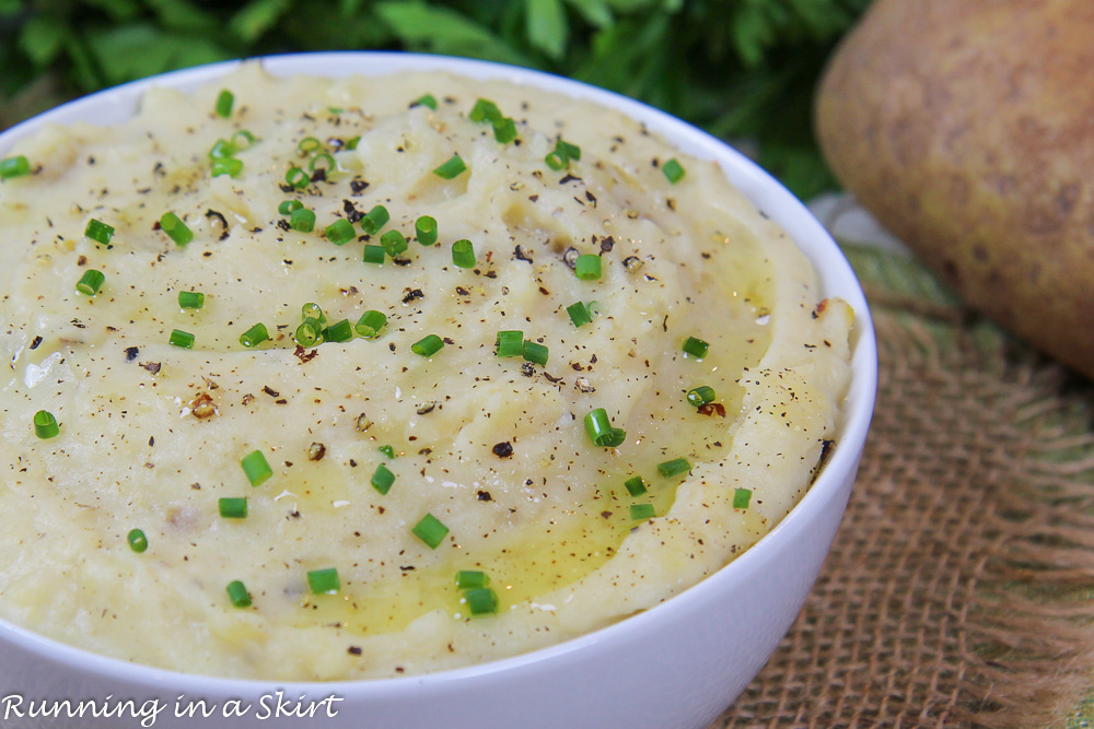 Mashed Potatoes in Crock Pot in a white serving bowl. The best slow cooker potatoes!