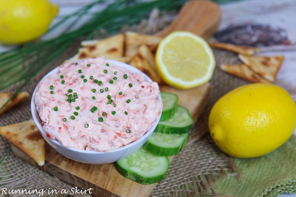 Healthy Smoked Salmon Dip in a white bowl on a wood cutting board.