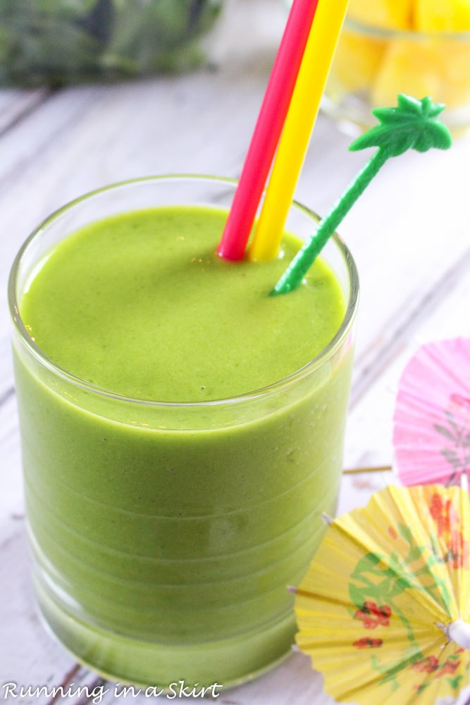 Island Green Smoothie with colorful straws and umbrellas.