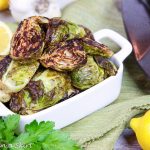 Roasted Brussels Sprouts with Garlic in a white serving dish.