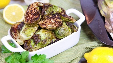 Roasted Brussels Sprouts with Garlic in a white serving dish.