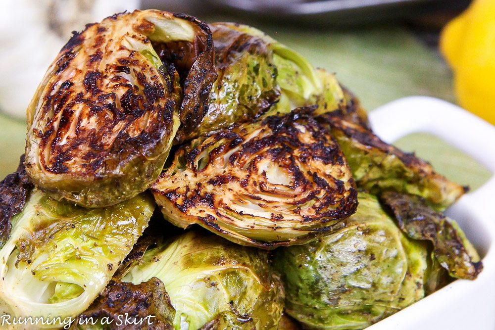 Marinated Brussels sprouts in a white serving dish.