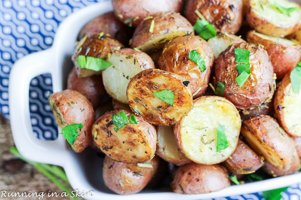 Herb and Garlic Roasted Baby Red Potatoes in a white baking dish.