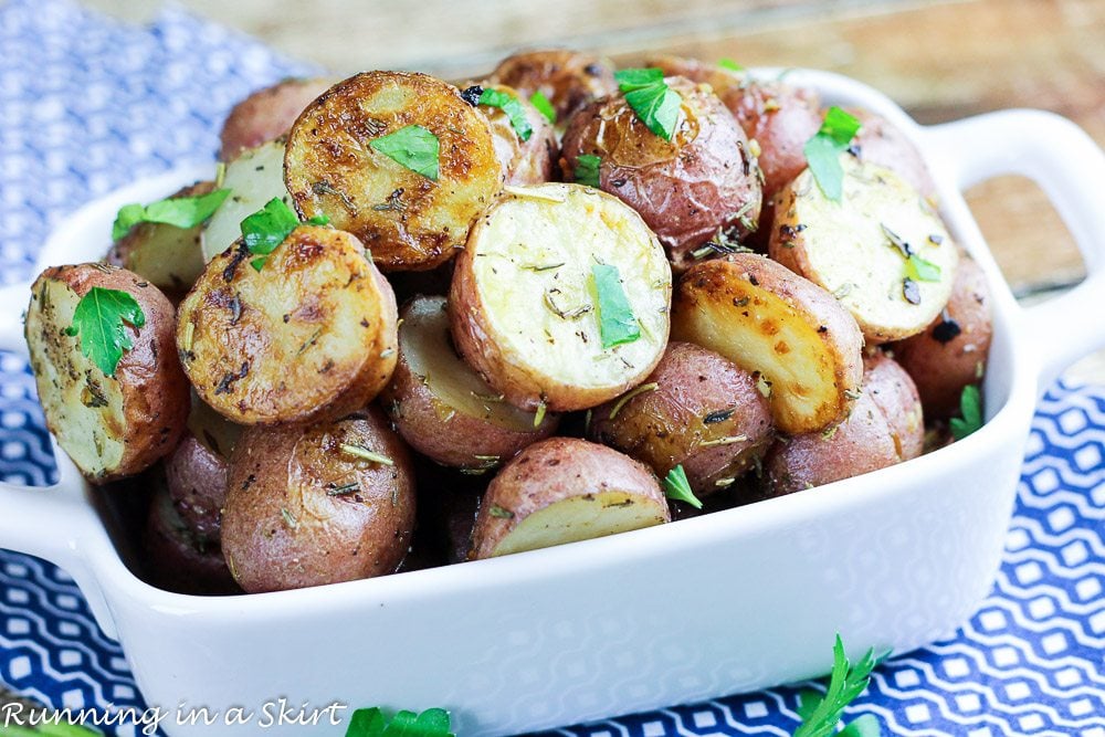 Herb and Garlic Roasted Baby Red Potatoes in a white baking dish.