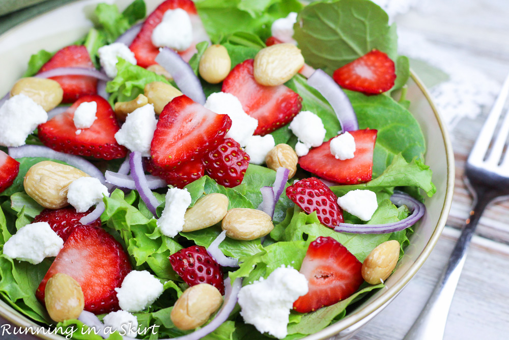 Kale Strawberry Salad with goat cheese in a bowl.