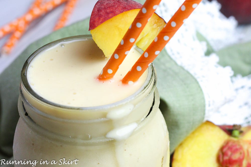 Peach Smoothie - Peaches and Cream Smoothie in a glass jar with peach straws.