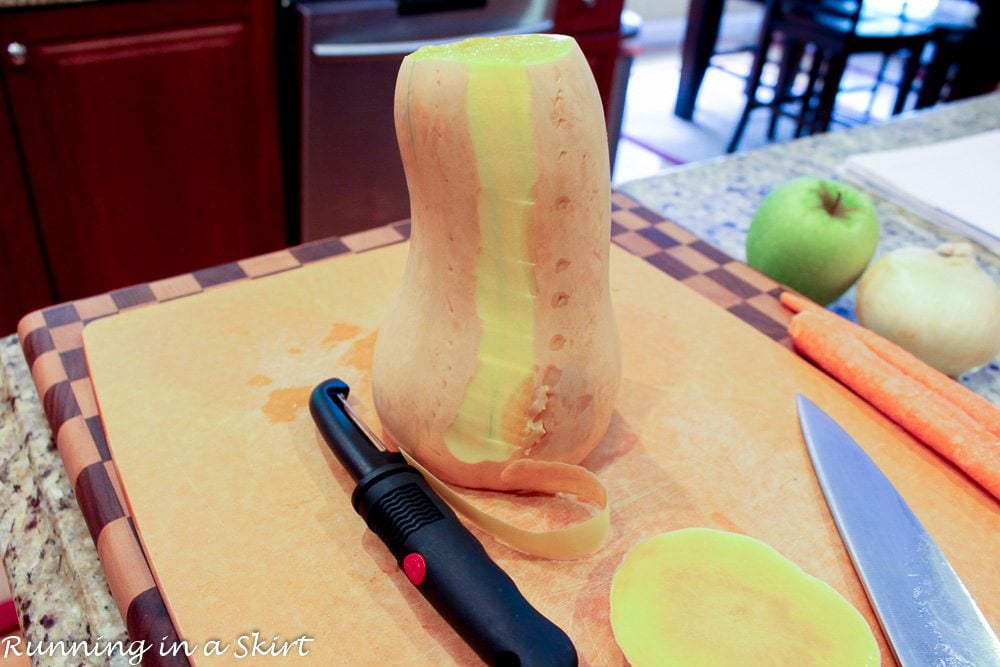 A whole butternut squash on a cutting board showing how to cut the butternut squash.