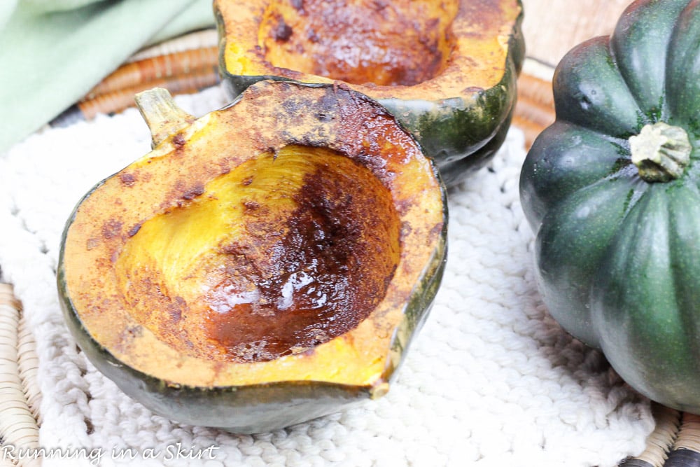 Easy Healthy Baked Acorn Squash halves on a white plate after roasting.