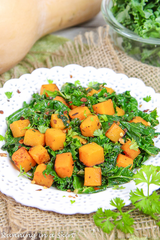 Butternut squash and kale on a white plate.