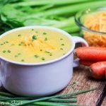 Cauliflower soup in a white serving bowl.