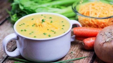 Cauliflower soup in a white serving bowl.