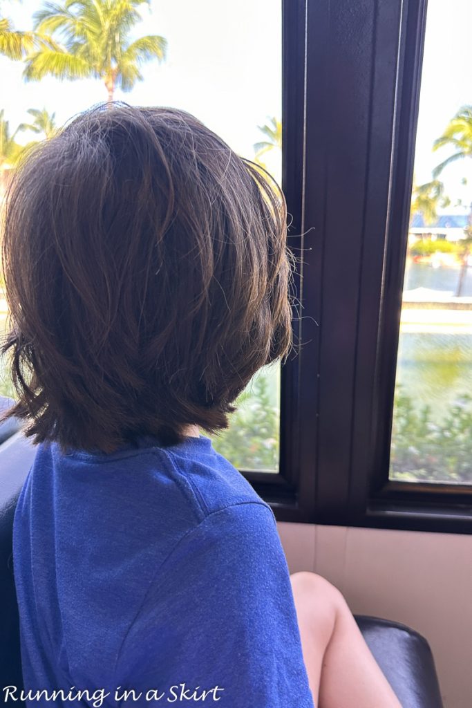 Kid riding monorail.