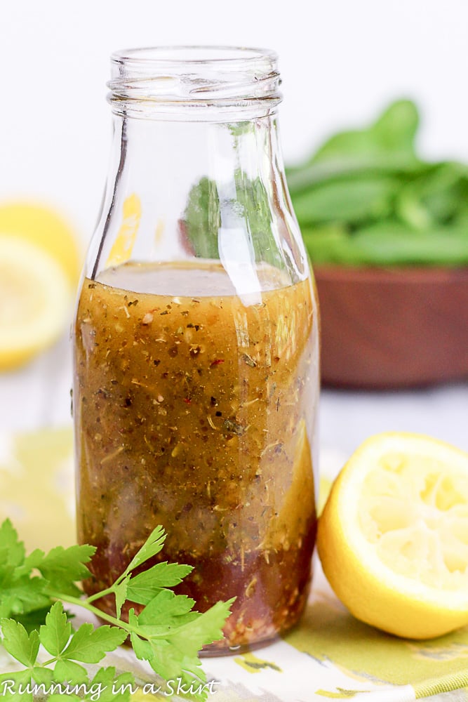 Healthy Greek Salad Dressing bottle with lemon and parsley. / Running in a Skirt