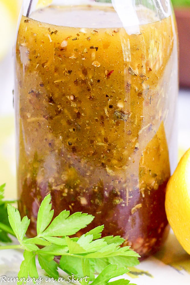 Close up of Healthy Greek Salad Dressing with no sugar in a glass bottle.
