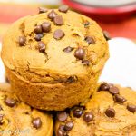 3 Ingredient Pumpkin Chocolate Chip Muffins stacked on a white plate.
