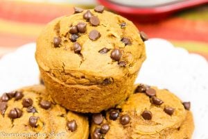 3 Ingredient Pumpkin Chocolate Chip Muffins stacked on a white plate.