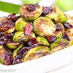 Maple Balsamic Brussels Sprouts and Cranberries in a white serving dish.