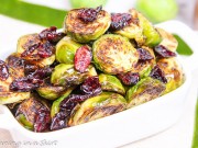 Maple Balsamic Brussels Sprouts and Cranberries in a white serving dish.