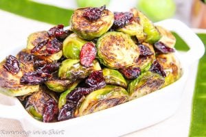 Maple Balsamic Brussels Sprouts and Cranberries in a white serving dish.