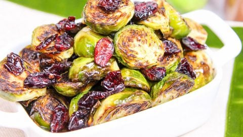 Maple Balsamic Brussels Sprouts and Cranberries in a white serving dish.