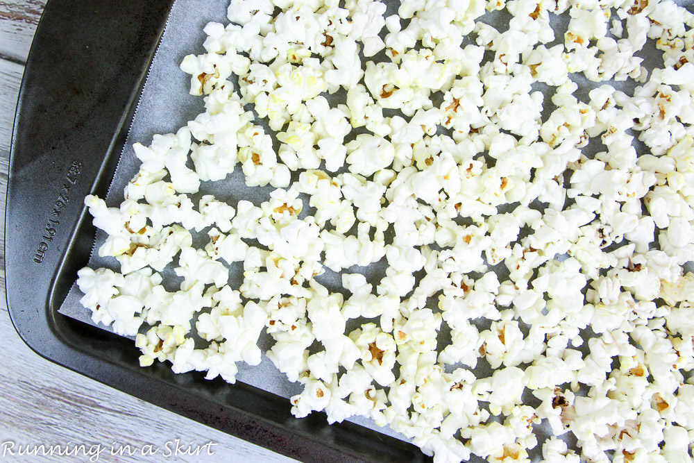 Plain popcorn on a baking sheet.