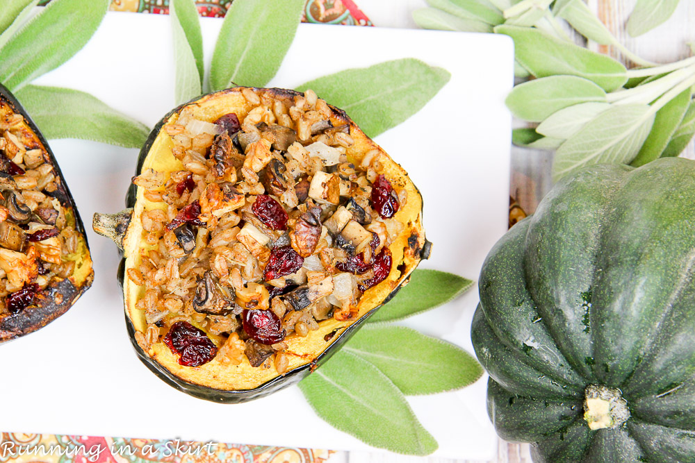 Stuffed acorn squash plated with fresh sage on a white plate.