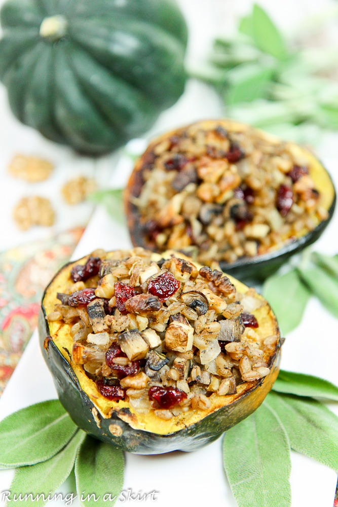 Stuffed acorn squash plated with fresh sage on a white plate.