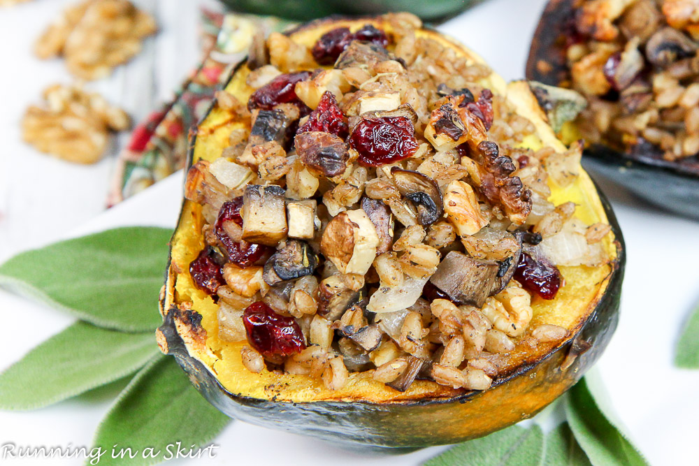 Stuffed acorn squash plated with fresh sage on a white plate.