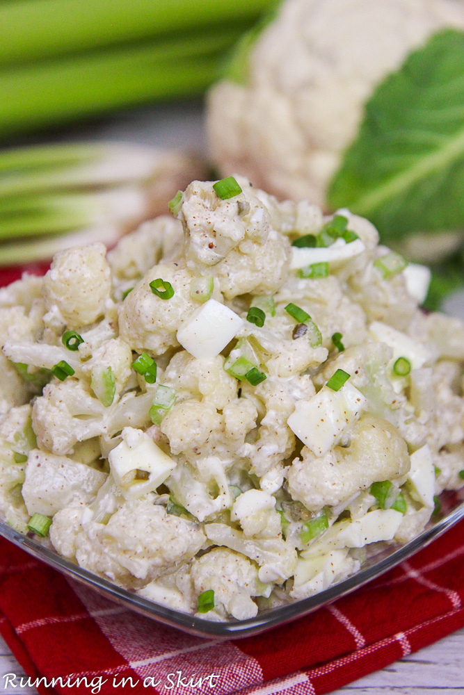 Cauliflower, green onion and celery on a red napkin.