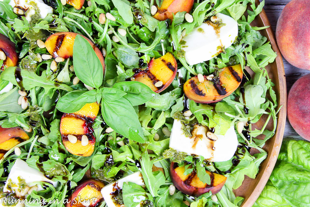 Caprese Grilled Peach Salad recipe in a bowl with arugala.