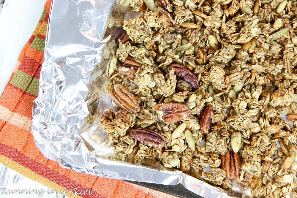 Process photo showing the pumpkin granola on a baking sheet.