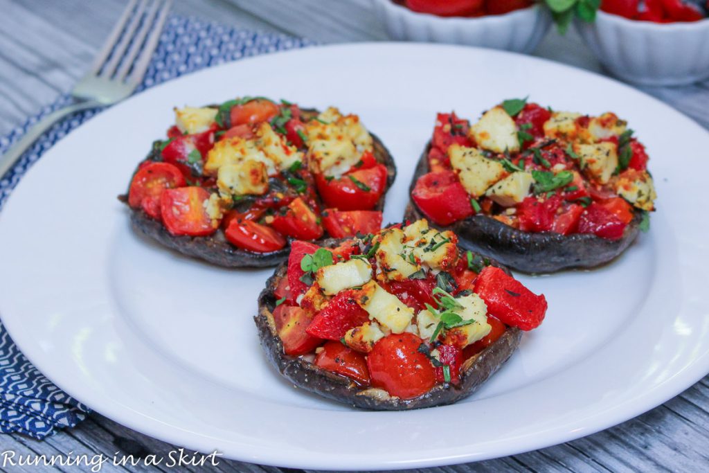 Vegetarian Stuffed Portobello Mushrooms - Tomato, Roasted Red Pepper & Goat Cheese Stuffed Portobello Mushrooms three on a white plate.