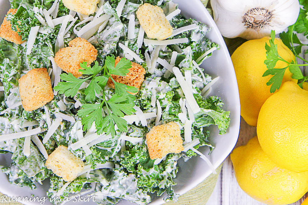 Overhead shot of the Kale Caesar Salad and dressing with lemons.