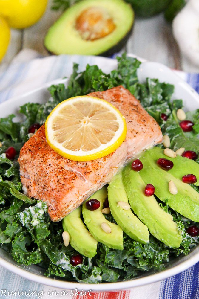 Baked Salmon Kale Salad with Tahini Dressing in a white bowl.
