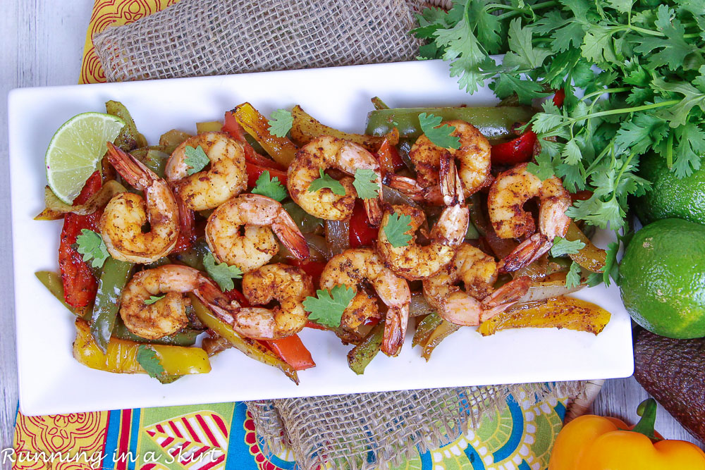 Overhead shot of Sheet Pan Shrimp Fajitas on a white serving plate.