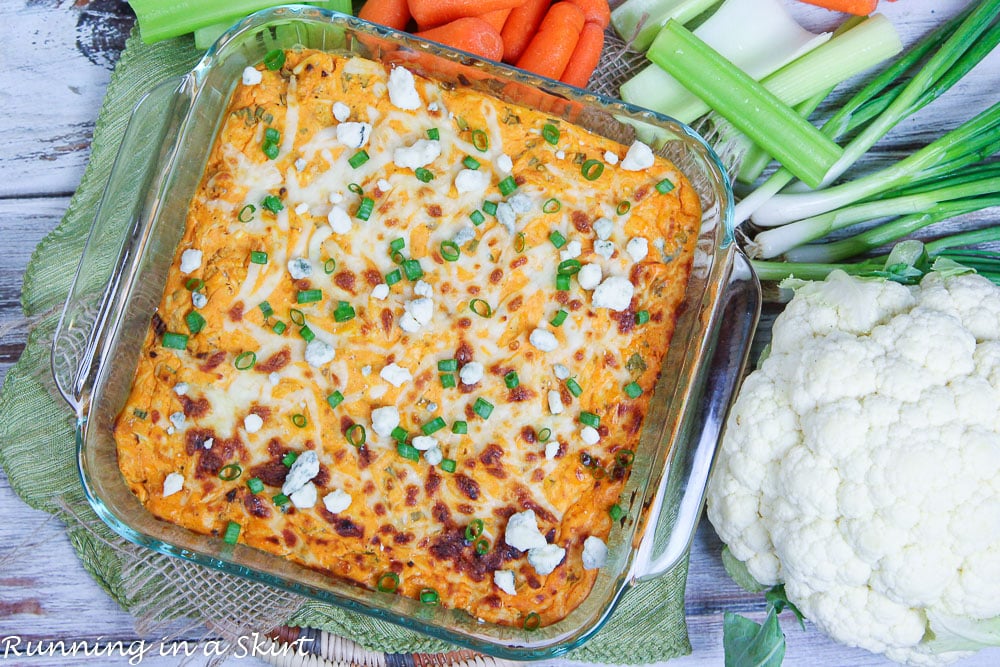 Buffalo Cauliflower Dip or a Vegetarian Buffalo Chicken Dip with ingredients around the pan.