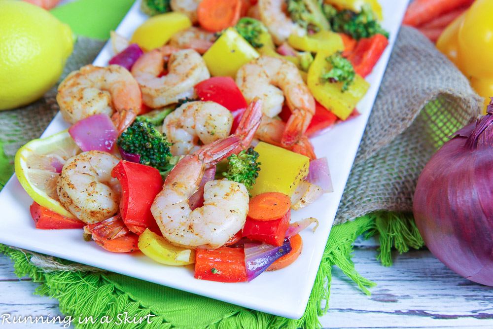 Sheet Pan Shrimp and Vegetables recipe on white plate with a napkin.